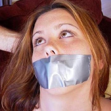 Woman with her lips duct taped shut