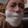 Blonde woman with eyes closed and face tensed, mouth covered by wide white microfoam tape showing a clear rounded bulge underneath